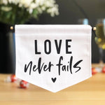 Love Never Fails Fabric Banner