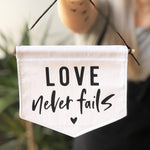 Love Never Fails Fabric Banner